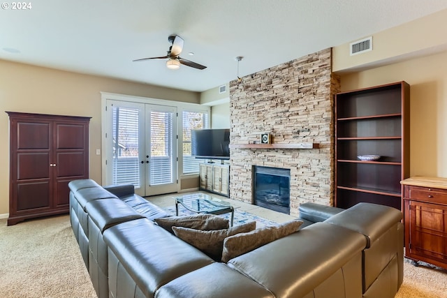 11529 SE Bateleur Way Unit C8, Happy Valley, OR 97086 - living area featuring ceiling fan, light carpet, a stone fireplace, and french doors