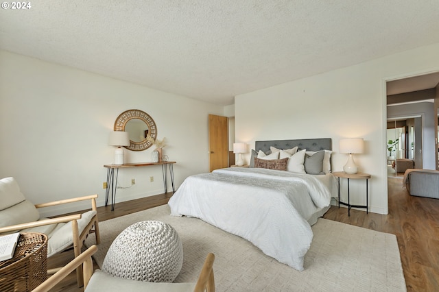 bedroom with hardwood / wood-style flooring and a textured ceiling