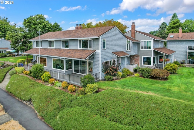 view of front of property with covered porch and a front lawn