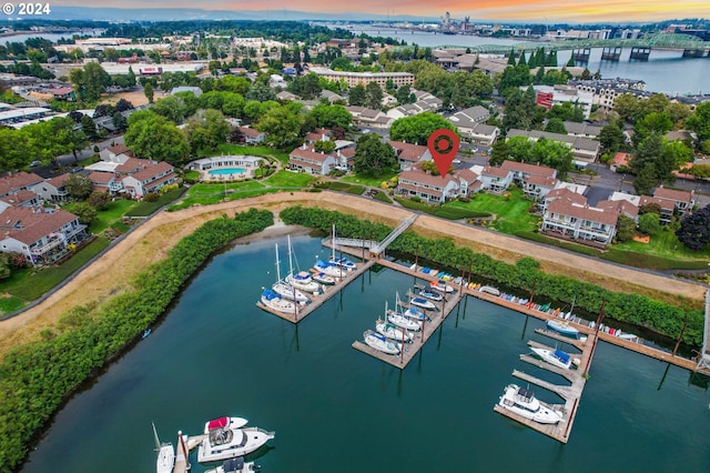 aerial view at dusk featuring a water view