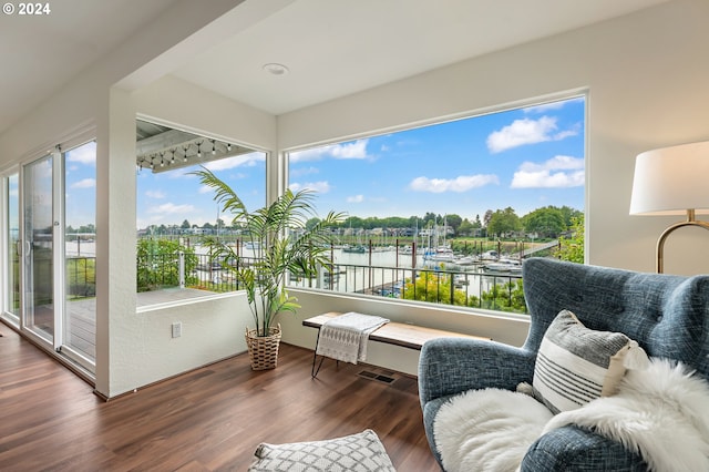 sunroom / solarium featuring a water view