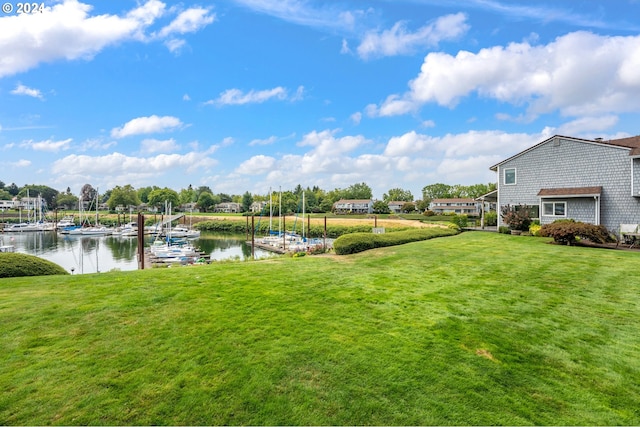 view of yard with a dock and a water view