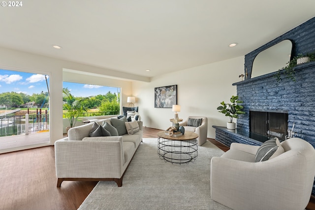 living room featuring light wood-type flooring and a fireplace