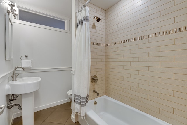 bathroom with toilet, tile patterned flooring, and shower / bath combination with curtain