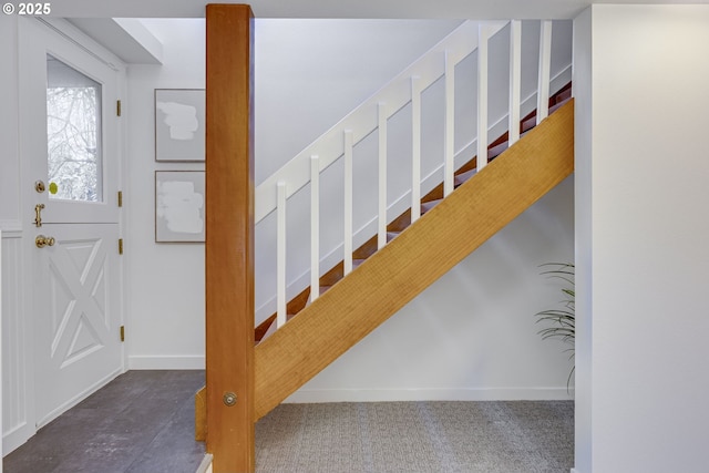 stairs featuring carpet flooring