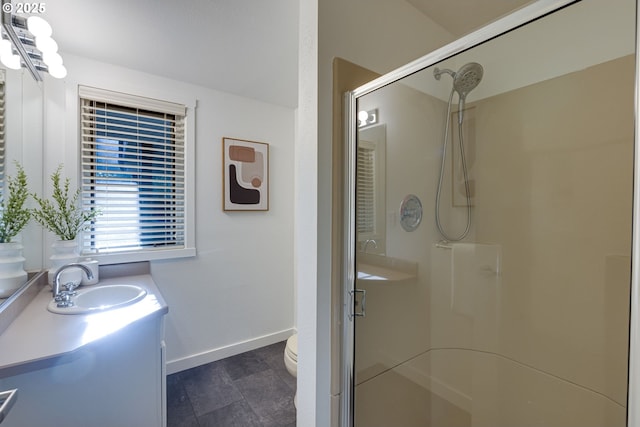 bathroom featuring toilet, a shower with door, and vanity