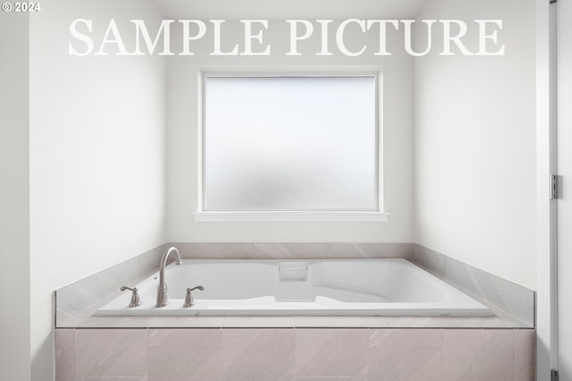 bathroom featuring tiled tub