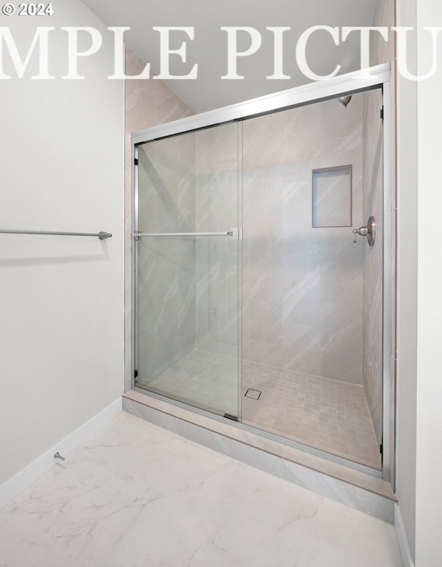 bathroom featuring a shower with shower door