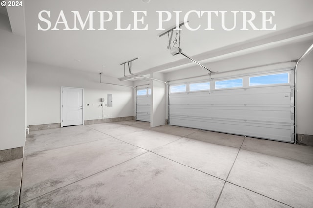 garage featuring electric panel and a garage door opener