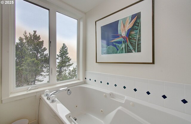 bathroom with a tub with jets