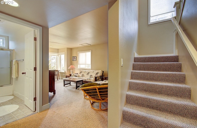 stairway with tile patterned floors and baseboards
