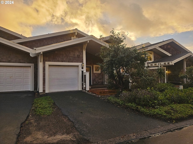 view of front of house featuring aphalt driveway and an attached garage