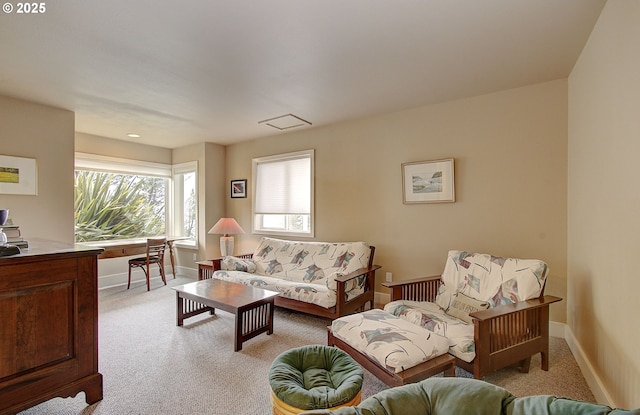 living area with light colored carpet and baseboards