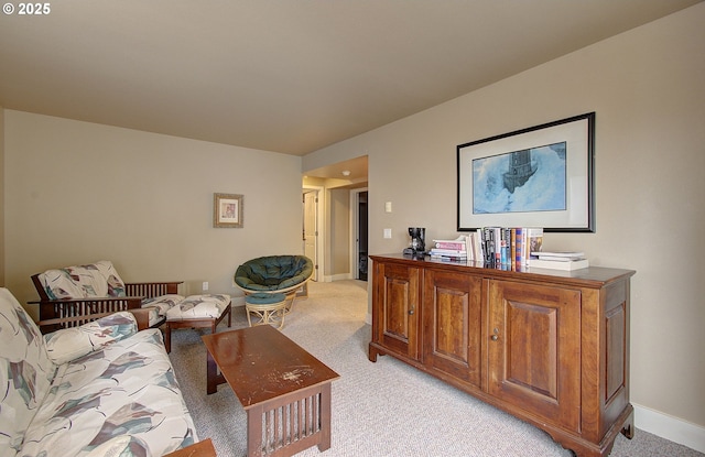 interior space featuring light colored carpet and baseboards
