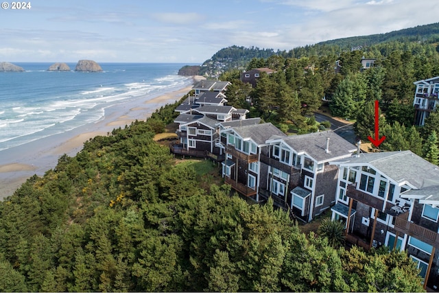 birds eye view of property with a beach view and a water view