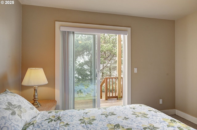 bedroom featuring access to exterior, carpet, and baseboards
