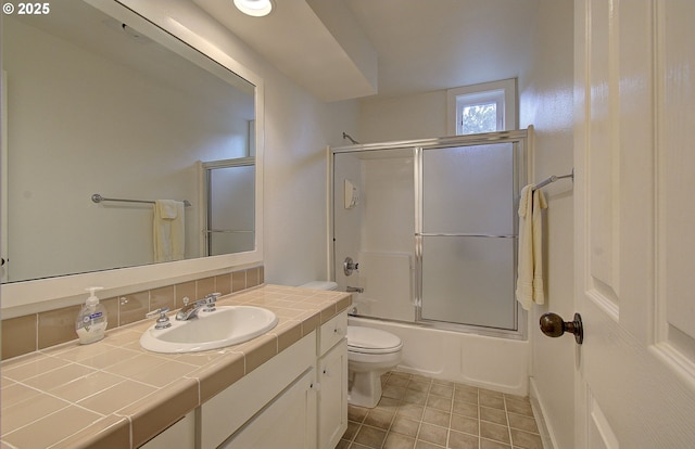 full bathroom featuring decorative backsplash, enclosed tub / shower combo, toilet, vanity, and tile patterned flooring