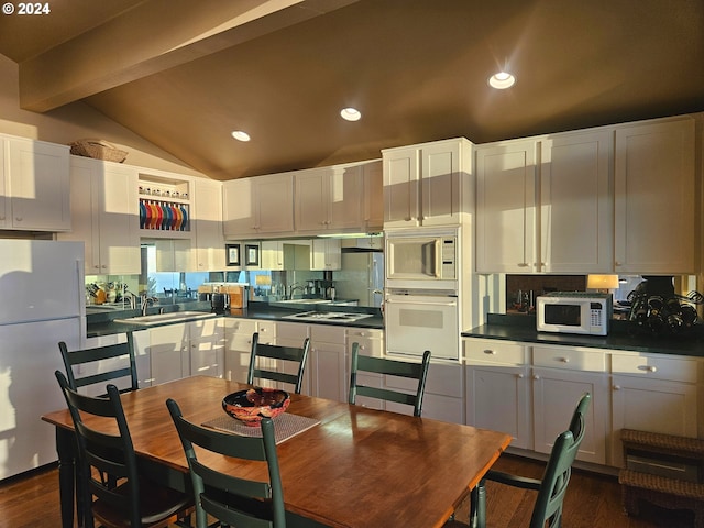 kitchen featuring white cabinets, lofted ceiling with beams, white appliances, dark hardwood / wood-style flooring, and sink