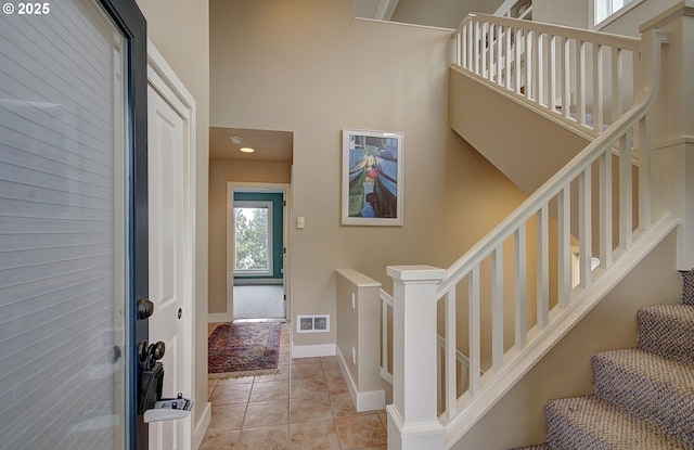 stairs with visible vents and tile patterned floors