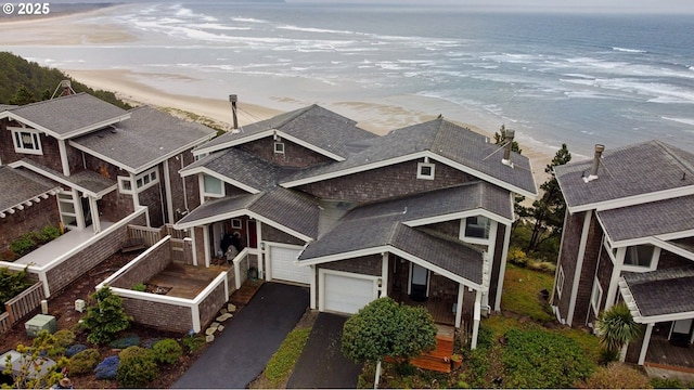 drone / aerial view with a beach view and a water view