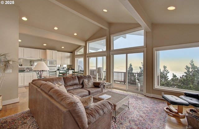 living area with beamed ceiling, baseboards, light wood-type flooring, recessed lighting, and high vaulted ceiling