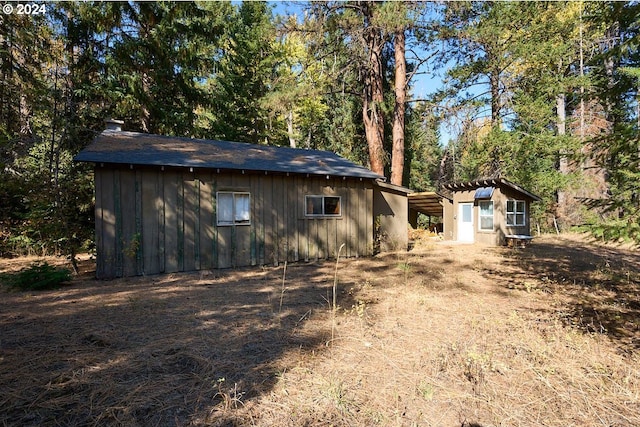 view of property exterior with a storage unit