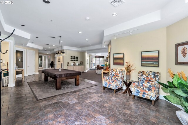 recreation room with a raised ceiling, rail lighting, and pool table