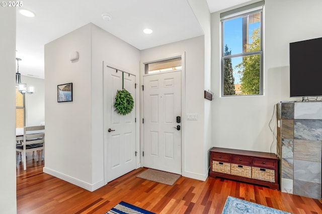 foyer featuring an inviting chandelier and hardwood / wood-style flooring