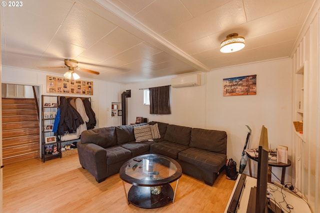 living room featuring ceiling fan, light wood-type flooring, and an AC wall unit