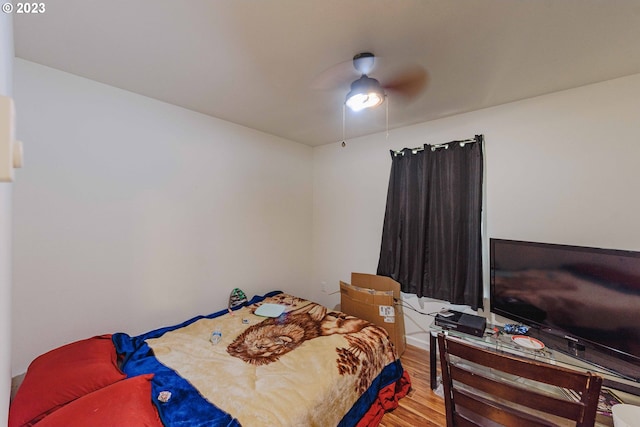 bedroom with ceiling fan and hardwood / wood-style flooring