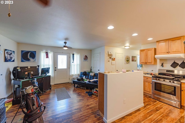 kitchen featuring hardwood / wood-style floors, ceiling fan, light brown cabinets, and stainless steel range with gas cooktop