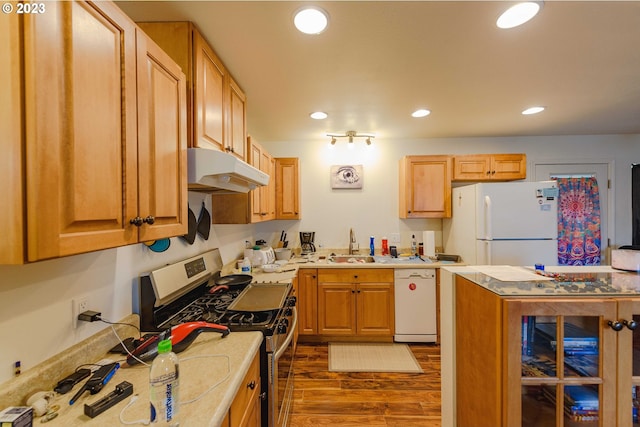 kitchen featuring white appliances, sink, and dark wood-type flooring