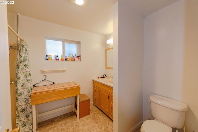 bathroom with curtained shower, vanity, and toilet