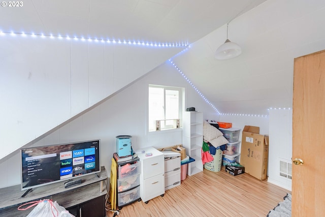 office area with vaulted ceiling and light hardwood / wood-style flooring