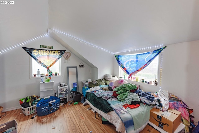 bedroom featuring vaulted ceiling and hardwood / wood-style flooring