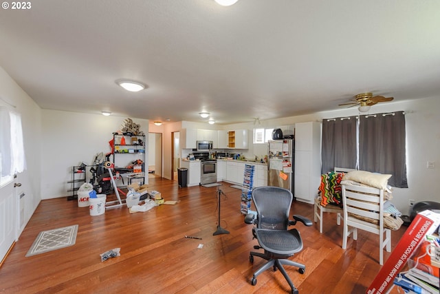 office with wood-type flooring and ceiling fan