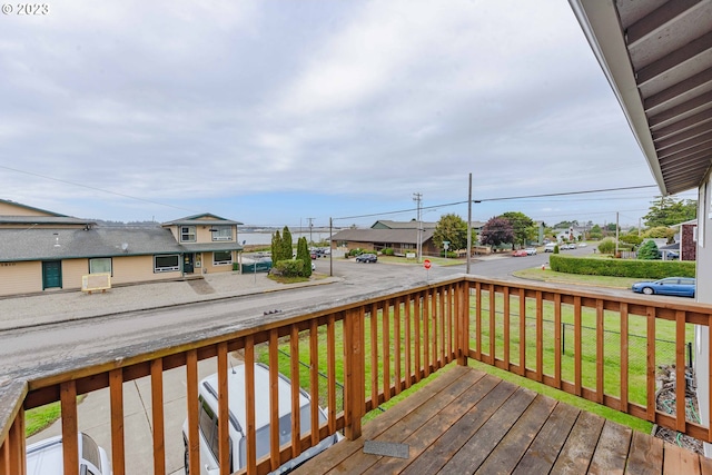 wooden deck with a lawn