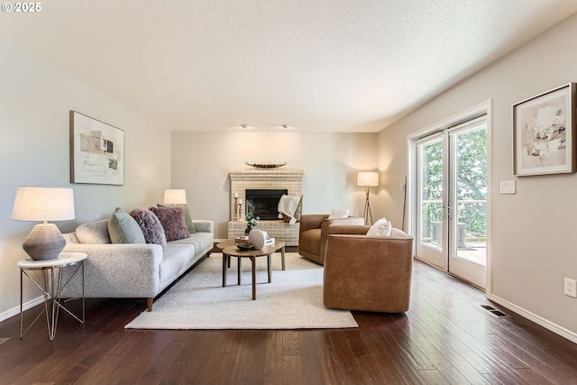 16675 SW Heceta Ct, Beaverton, OR 97007 - living room with dark wood-style flooring, baseboards, and a fireplace