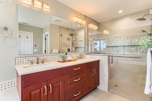 16675 SW Heceta Ct, Beaverton, OR 97007 - bathroom with a shower stall, double vanity, tile patterned floors, and backsplash