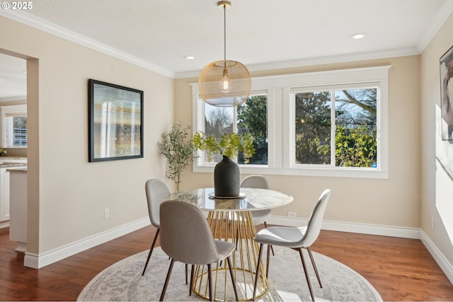 dining room with dark hardwood / wood-style flooring and ornamental molding