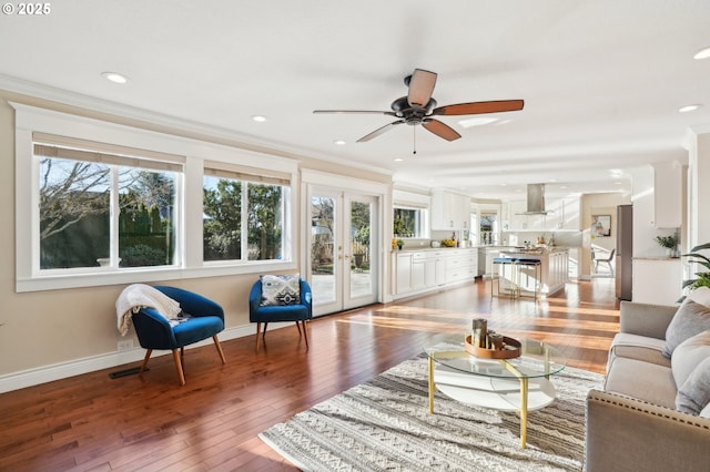 living room with hardwood / wood-style flooring, ornamental molding, and french doors