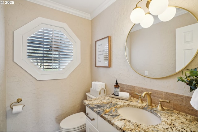 bathroom featuring ornamental molding, toilet, and vanity