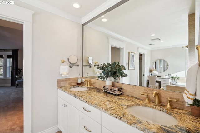 bathroom with crown molding and vanity