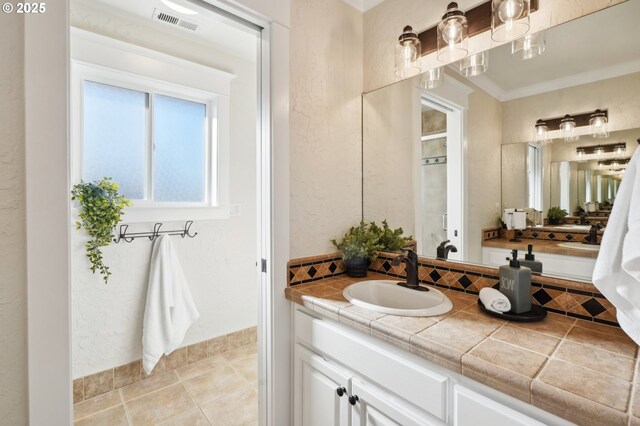 bathroom featuring vanity, tile patterned flooring, and decorative backsplash