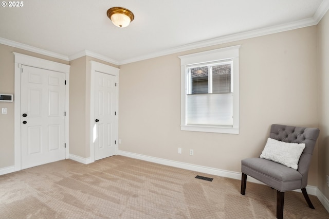 sitting room featuring crown molding and light colored carpet