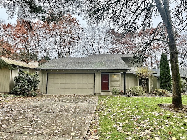 ranch-style house featuring a front yard and a garage