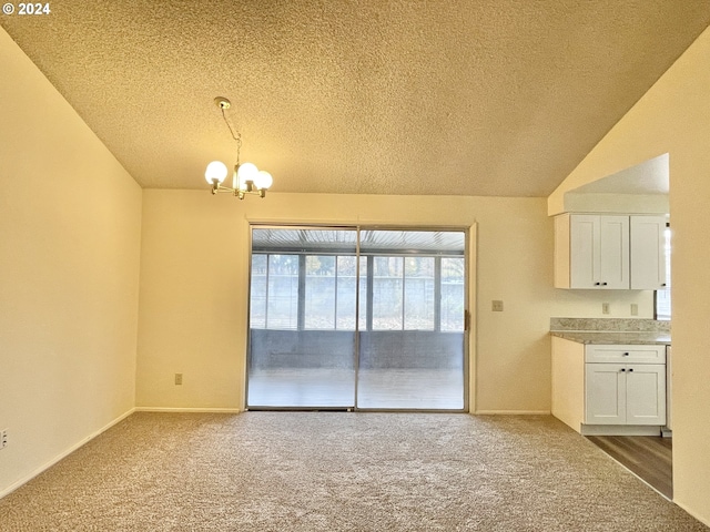 unfurnished dining area with baseboards, lofted ceiling, a textured ceiling, carpet flooring, and a chandelier