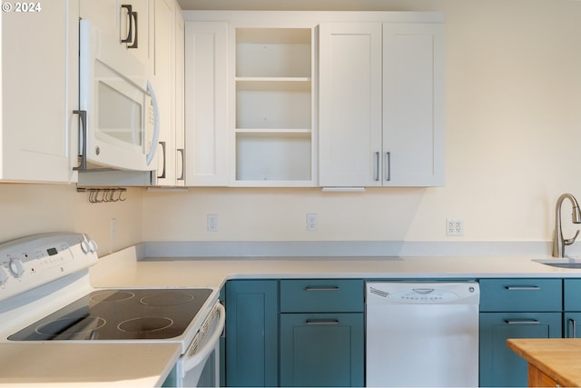 kitchen featuring sink, blue cabinets, butcher block countertops, white appliances, and white cabinets