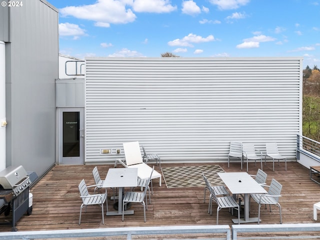 wooden terrace featuring area for grilling