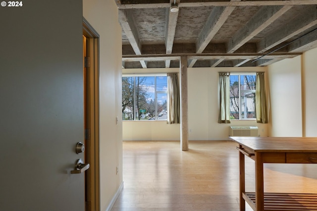 interior space with light wood-type flooring and an AC wall unit